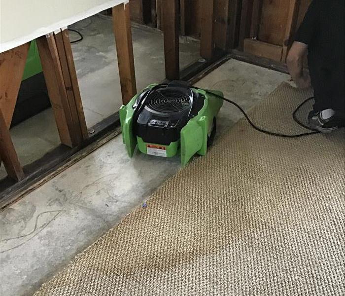 A home with water damage required sheetrock removal as well as green air movers to properly dry the affected area