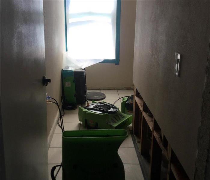 Hallway with drying equipment and floodcuts.